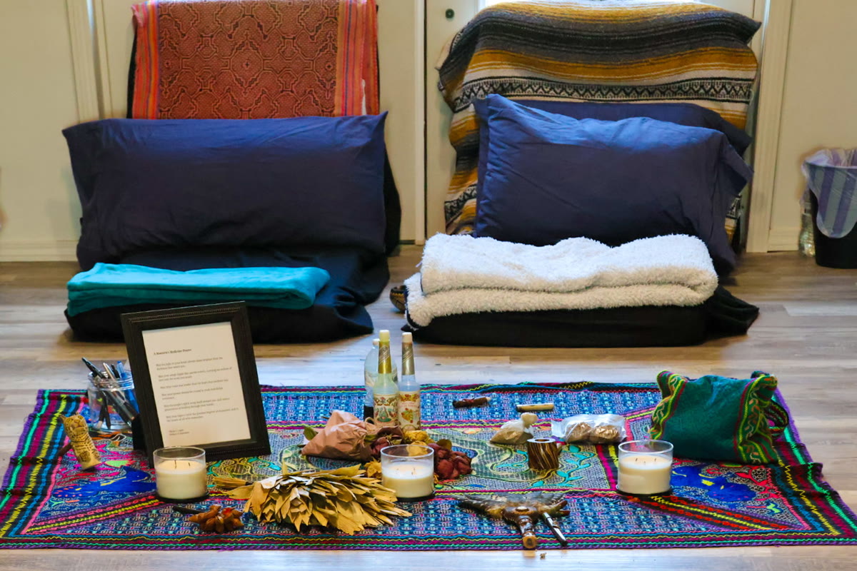 Candlelight on the ceremony altar, set with cushions and Shipibo textiles