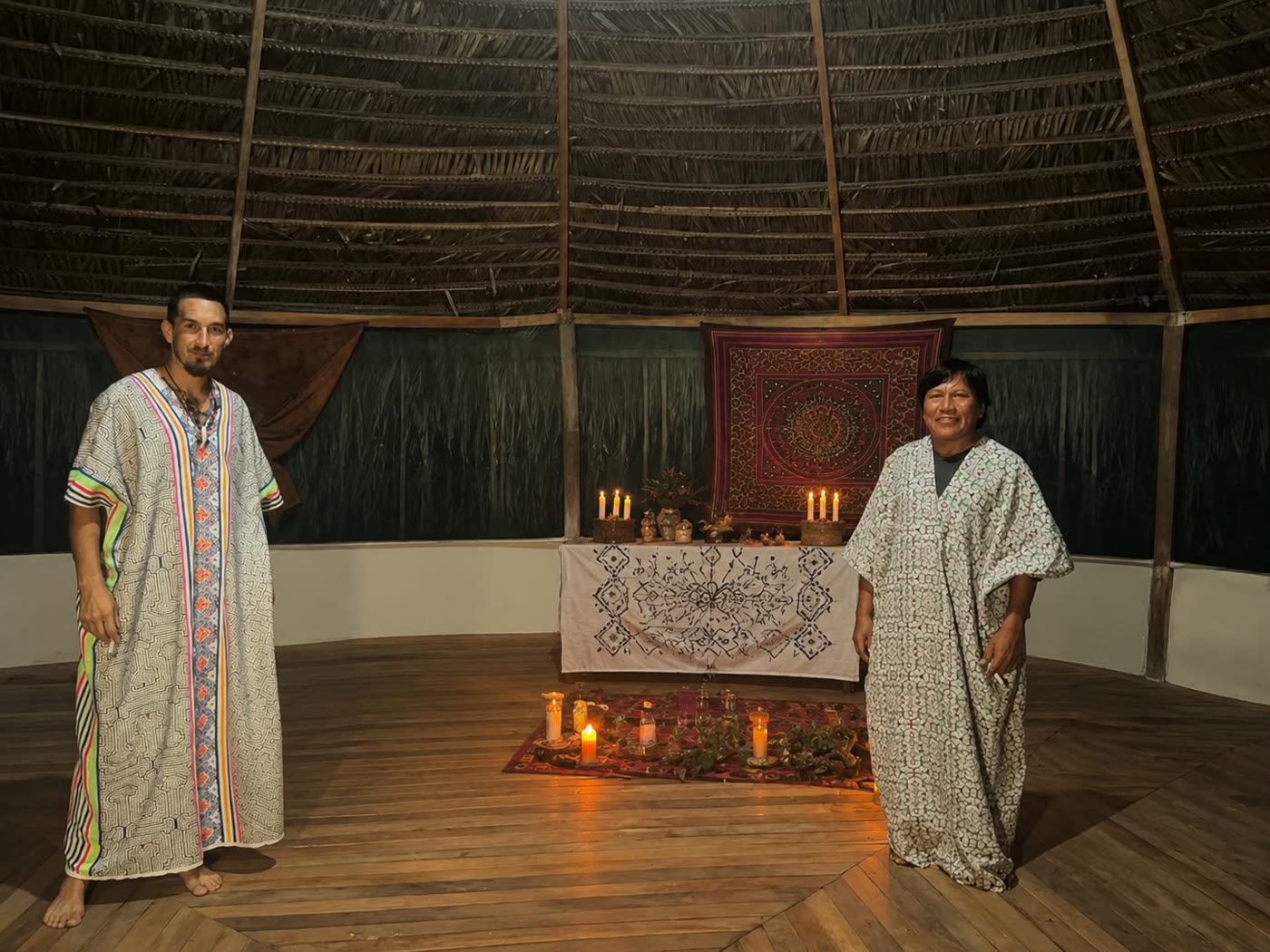 A candlelit altar in a traditional Shipibo maloca, set for ceremony