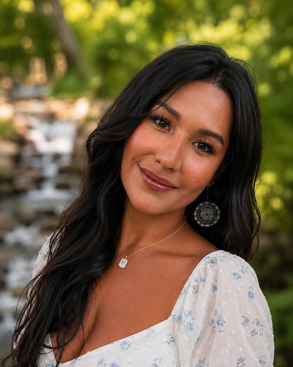 Maria Lopez, Integration Specialist, photographed outdoors beside a stream